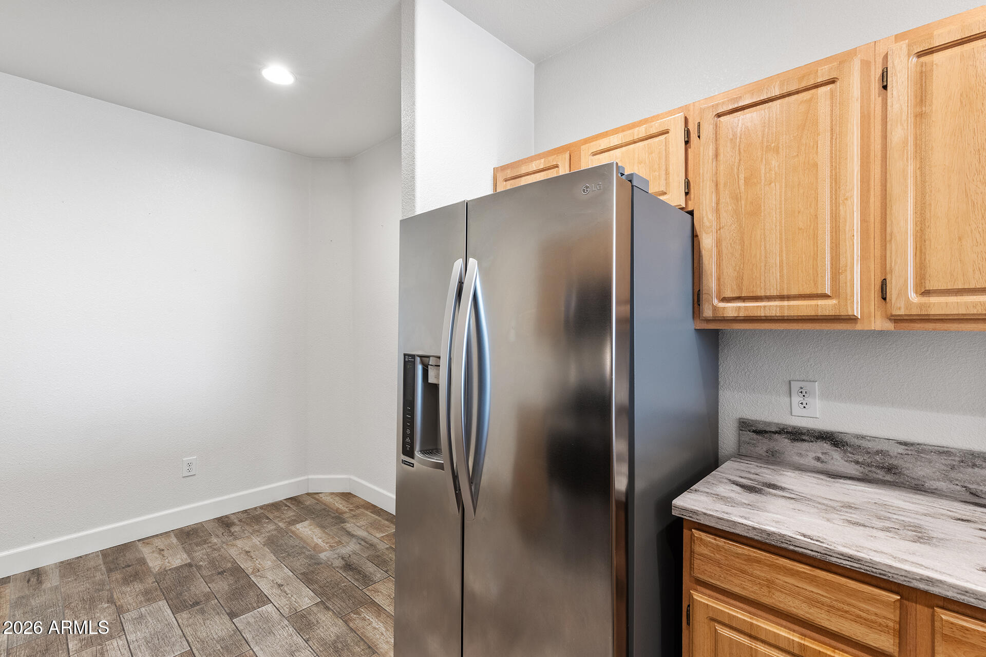 7101 West Beardsley Road, Unit 1303 Glendale, AZ 85308 - Photo 11 of 53 a metallic refrigerator freezer sitting in a kitchen