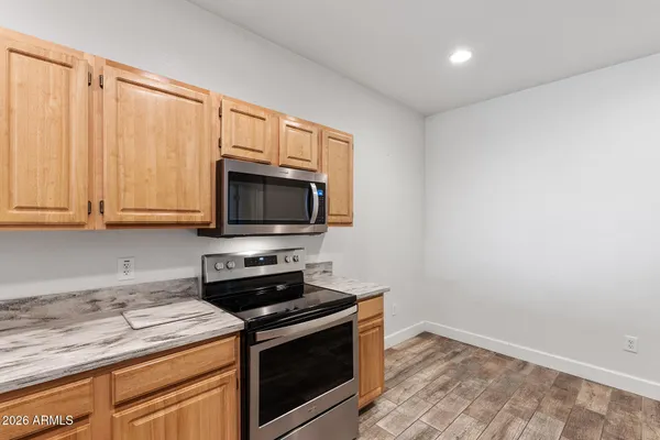 a stove top oven sitting inside of a kitchen