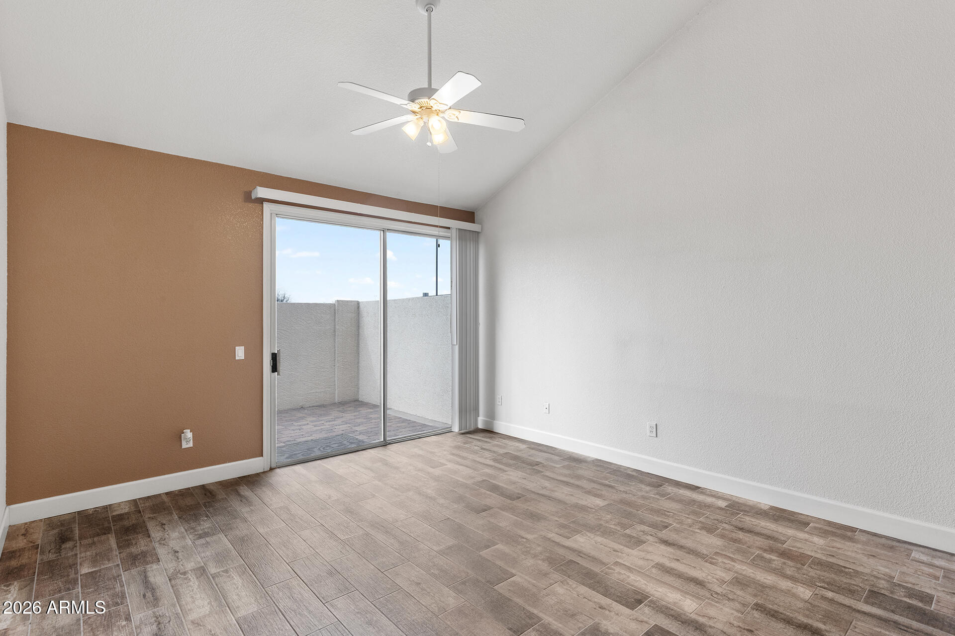 7101 West Beardsley Road, Unit 1303 Glendale, AZ 85308 - Photo 15 of 53 an empty room with wooden floor and chandelier fan