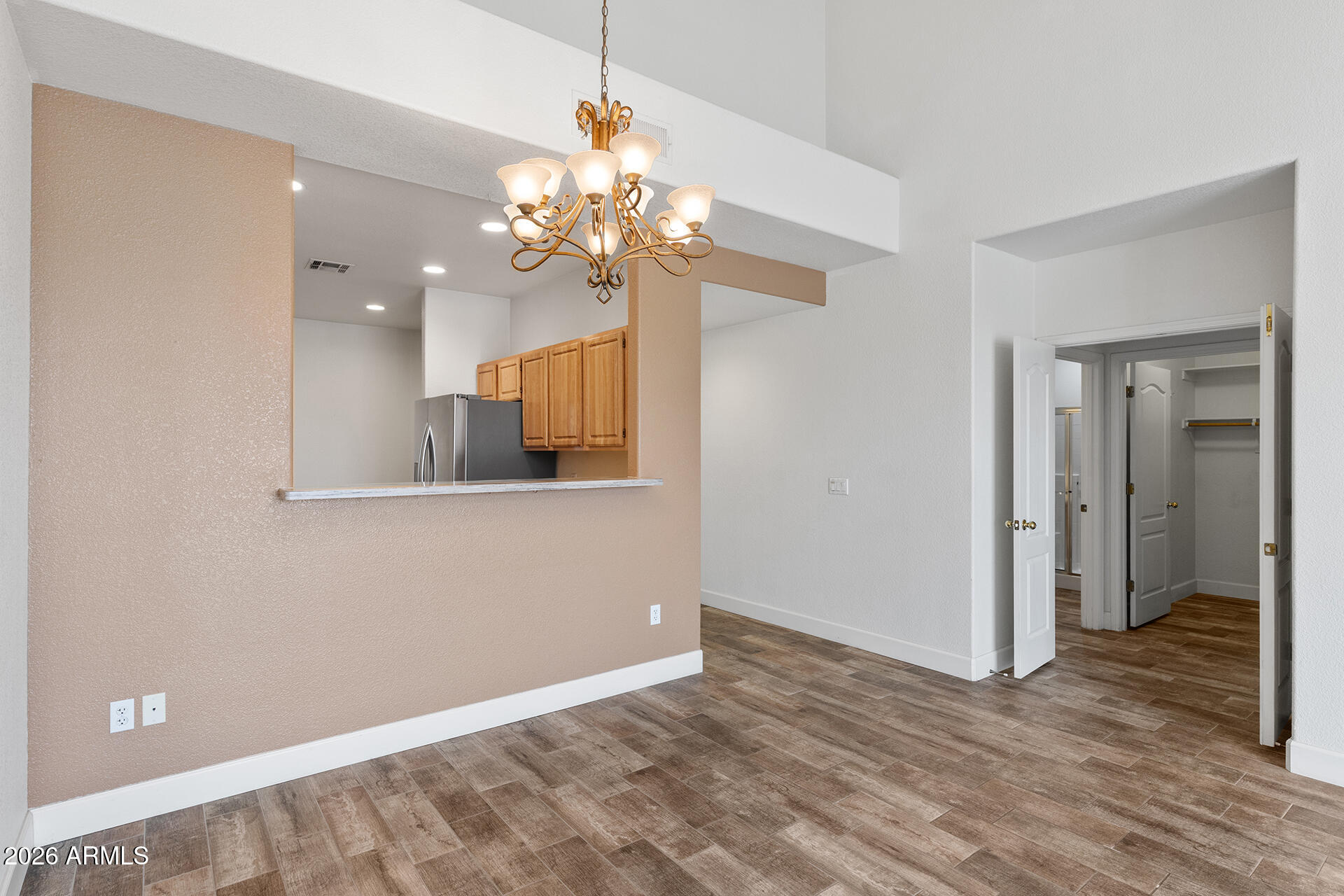 7101 West Beardsley Road, Unit 1303 Glendale, AZ 85308 - Photo 19 of 53 a view of a chandelier in a room with a chandelier fan