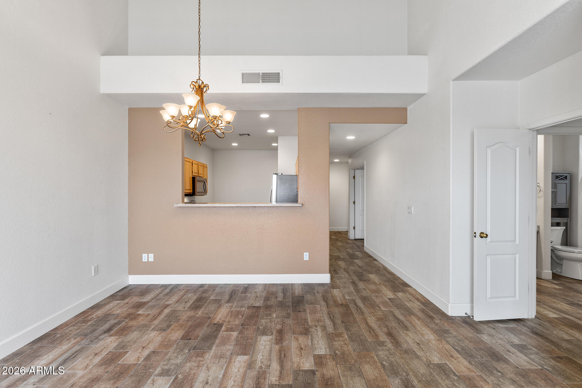 7101 West Beardsley Road, Unit 1303 Glendale, AZ 85308 - Photo 20 of 53 a view of a chandelier and wooden floor