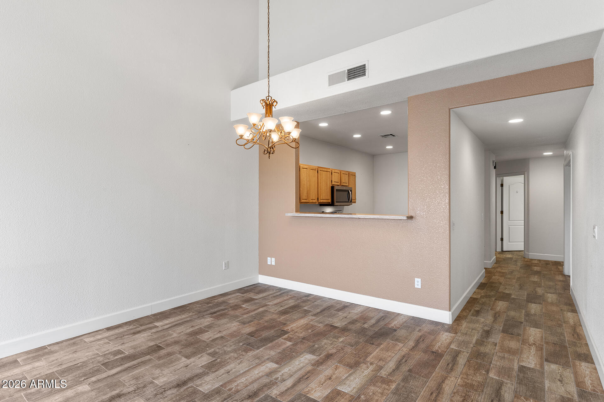7101 West Beardsley Road, Unit 1303 Glendale, AZ 85308 - Photo 21 of 53 a view of a hallway with a chandelier