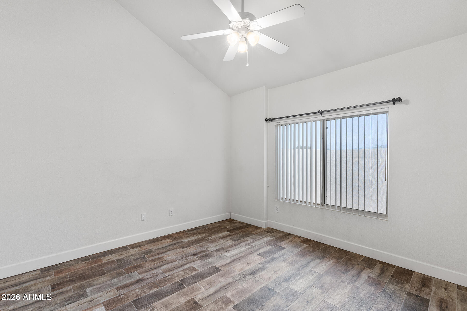 7101 West Beardsley Road, Unit 1303 Glendale, AZ 85308 - Photo 25 of 53 an empty room with a window and ceiling fan