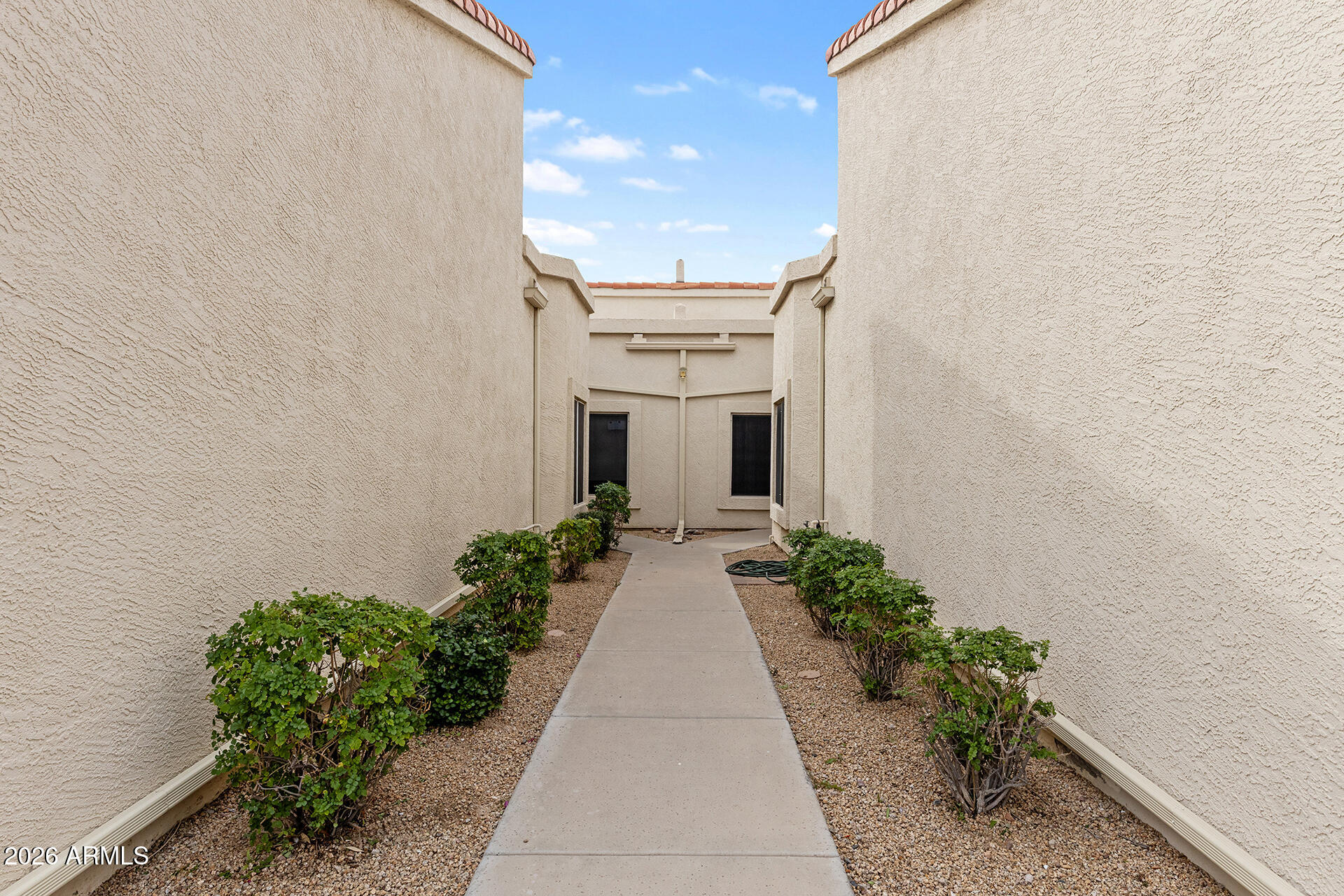 7101 West Beardsley Road, Unit 1303 Glendale, AZ 85308 - Photo 5 of 53 a view of a house with flower plants