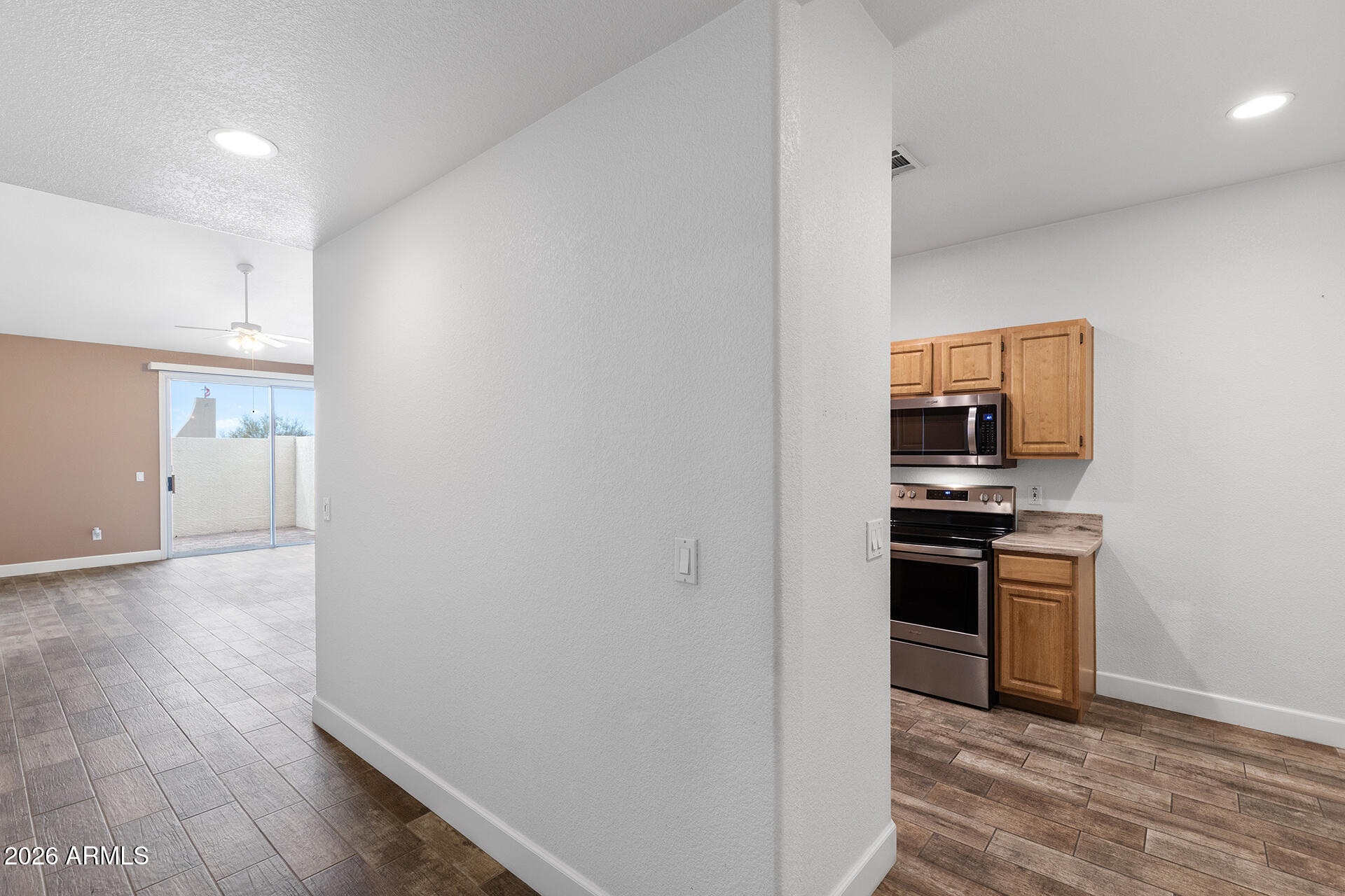 7101 West Beardsley Road, Unit 1303 Glendale, AZ 85308 - Photo 6 of 53 a kitchen with cabinets and stainless steel appliances