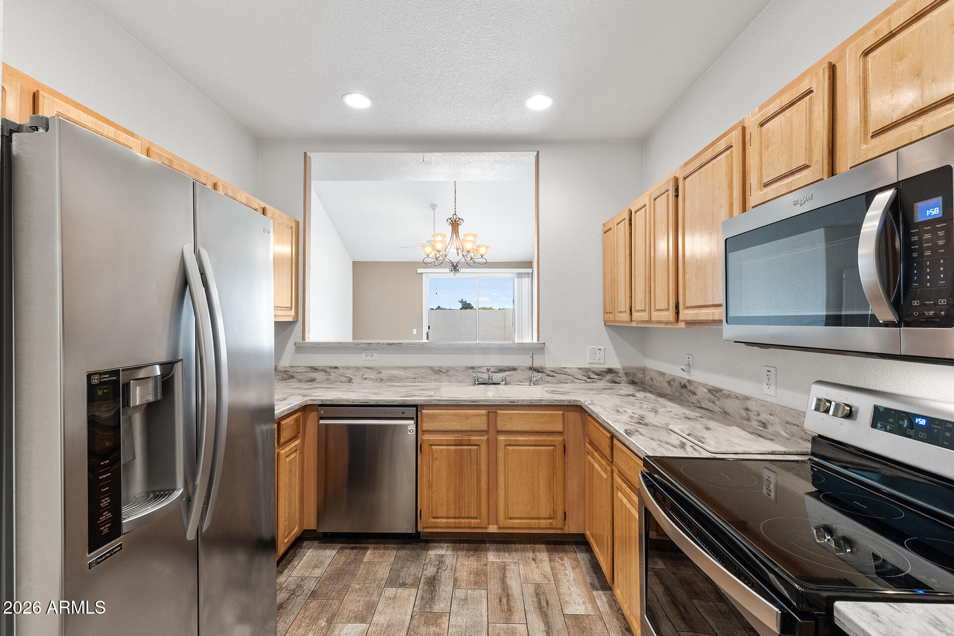 7101 West Beardsley Road, Unit 1303 Glendale, AZ 85308 - Photo 8 of 53 a kitchen with stainless steel appliances granite countertop a sink stove and refrigerator