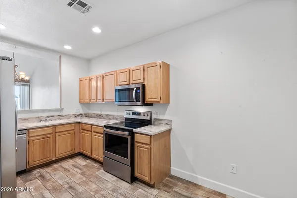 a kitchen with stainless steel appliances granite countertop a refrigerator and a sink