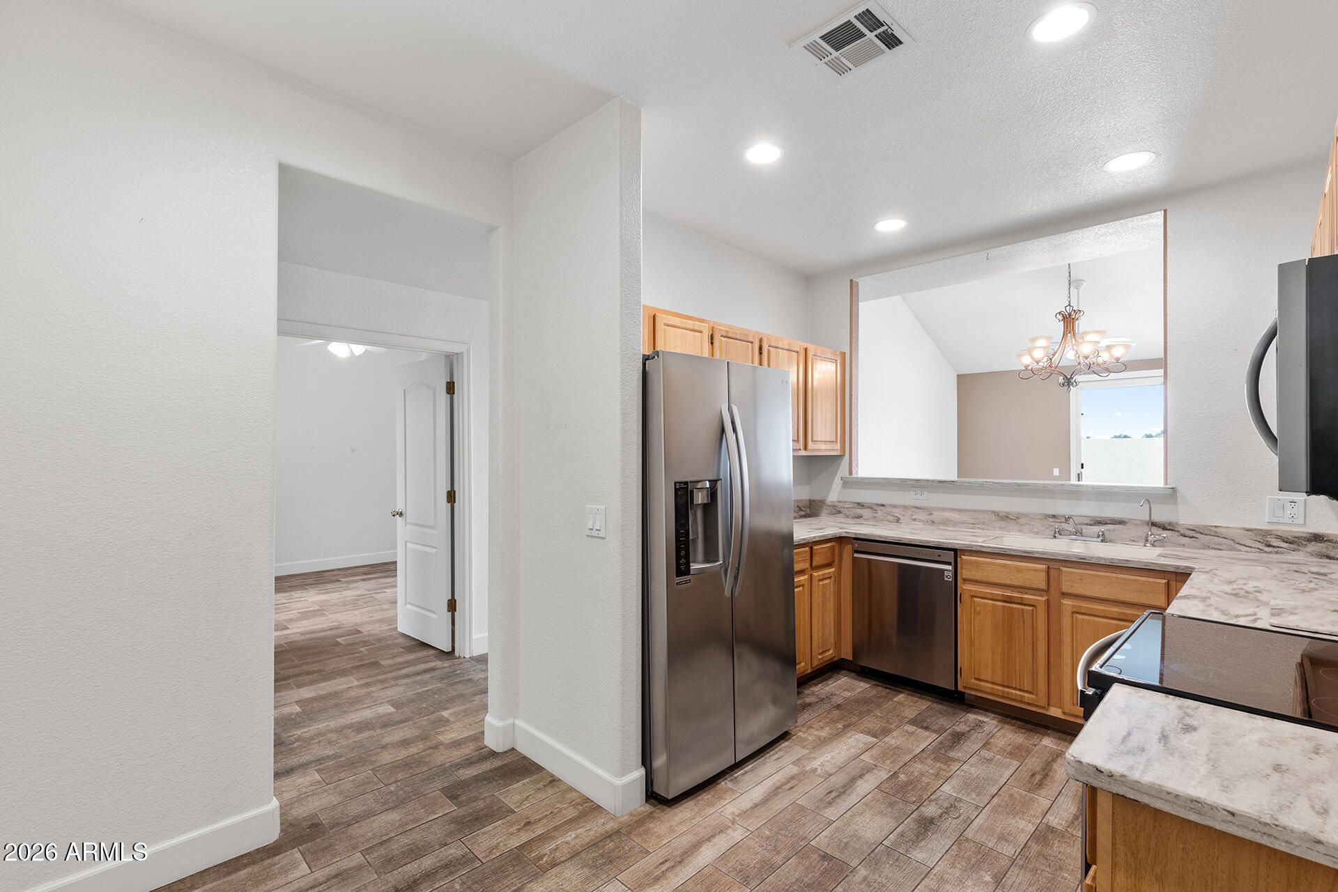 7101 West Beardsley Road, Unit 1303 Glendale, AZ 85308 - Photo 10 of 53 a kitchen with stainless steel appliances granite countertop a refrigerator and a sink