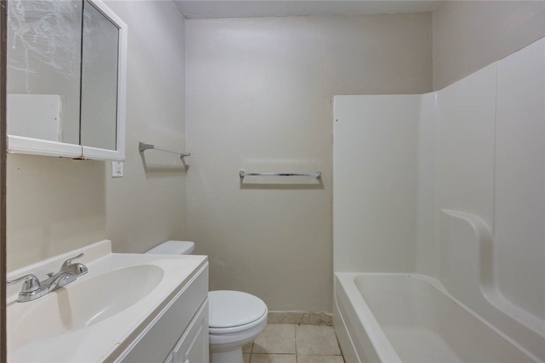 2437 Nemec Street Corpus Christi, TX 78415 - Photo 13 of 38 a white toilet sitting next to a bath tub