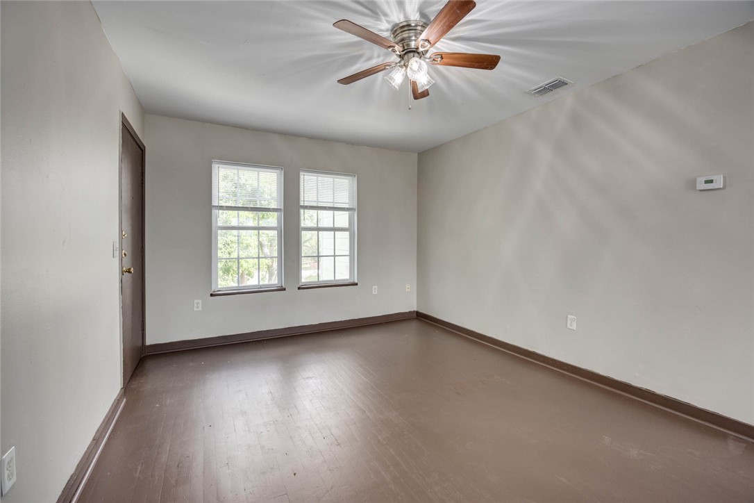 2437 Nemec Street Corpus Christi, TX 78415 - Photo 18 of 38 an empty room with wooden floor fan and windows