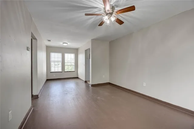 wooden floor in an empty room with a window