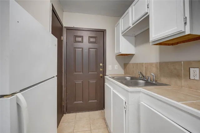a kitchen with a sink and a refrigerator
