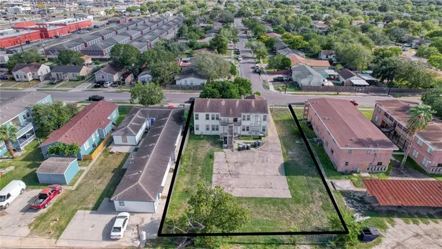an aerial view of residential houses with outdoor space