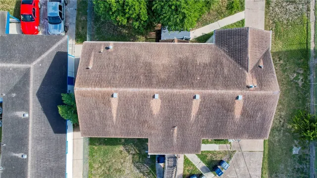 an aerial view of a house with a yard and plants