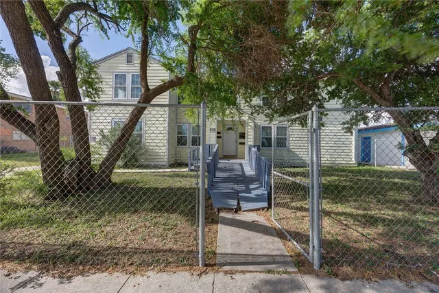 a view of house with a backyard