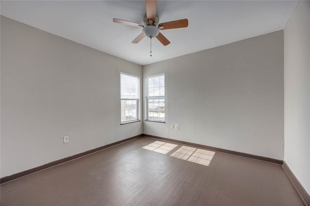 2437 Nemec Street Corpus Christi, TX 78415 - Photo 9 of 38 wooden floor in an empty room with a window