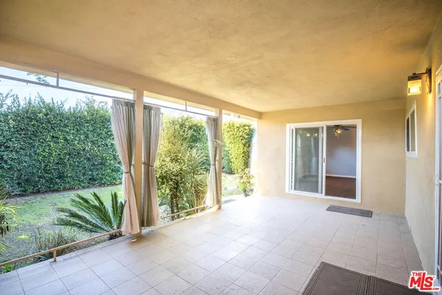 a view of a house with backyard and balcony