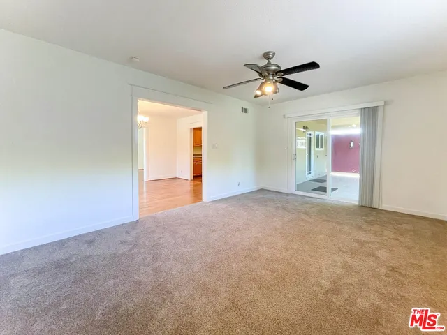 a view of empty room with ceiling fan
