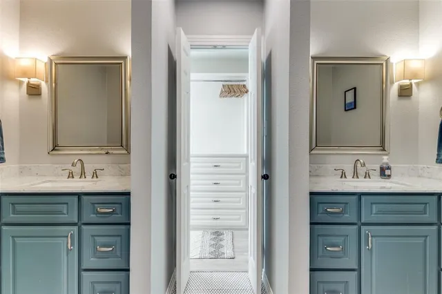 a bathroom with a double vanity sink and a mirror