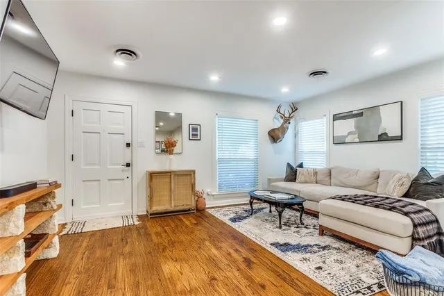 a living room with furniture and wooden floor