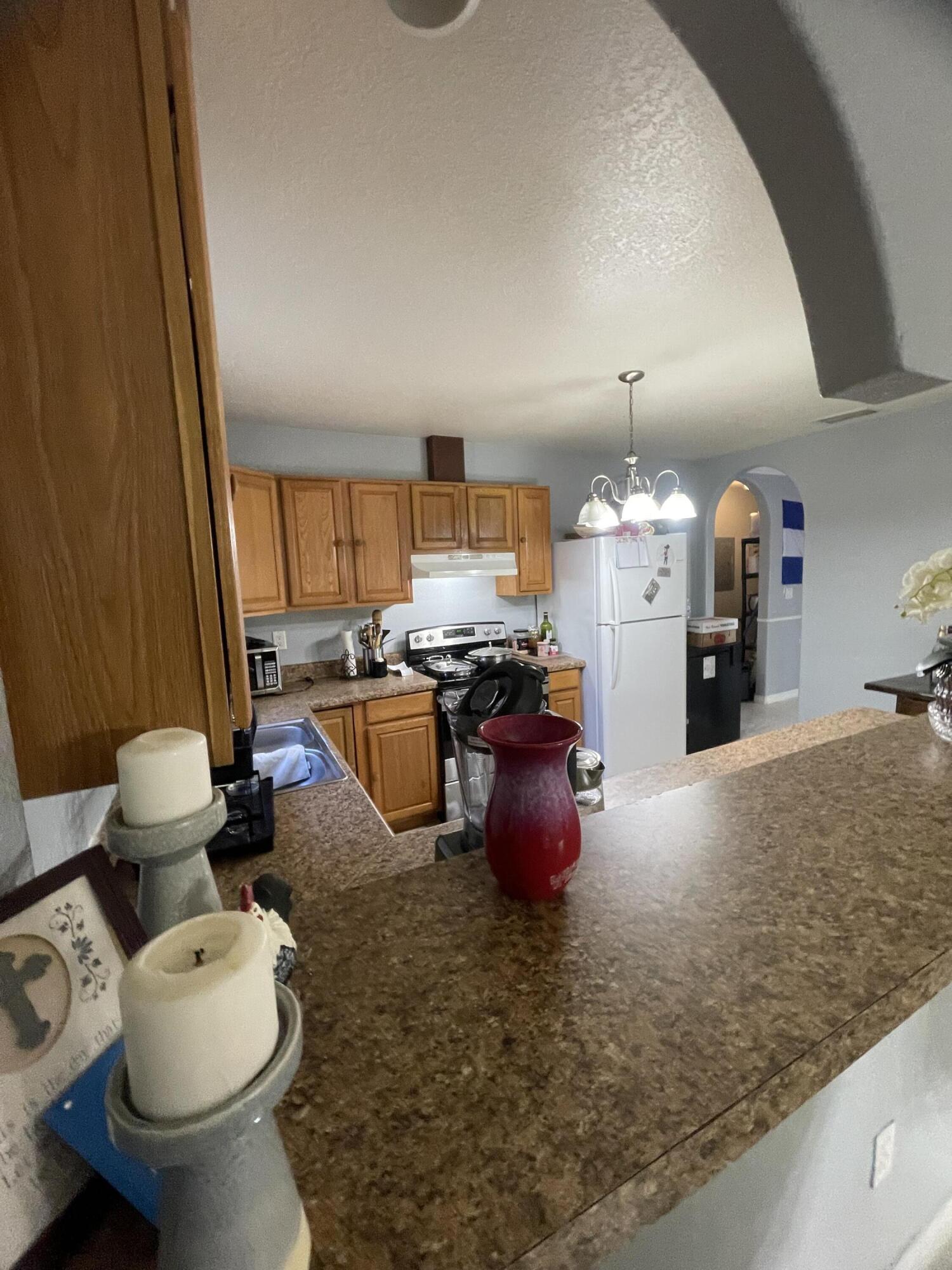 1220 A Road LaBelle, FL 33935 - Photo 17 of 42 a room with wooden cabinets and stainless steel appliances