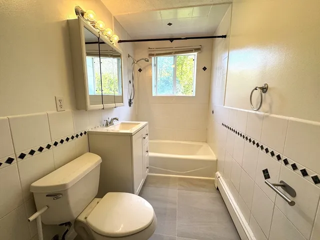 a bathroom with a sink a toilet and a bathtub