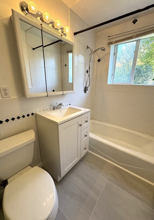 44 Westgate Road, Unit 5 Boston, MA 02467 - Photo 12 of 15 a bathroom with a sink a toilet and a bathtub