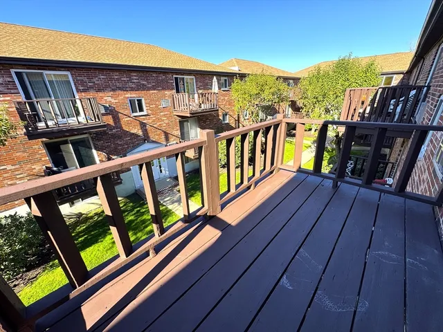 a view of a balcony with wooden floor and city view