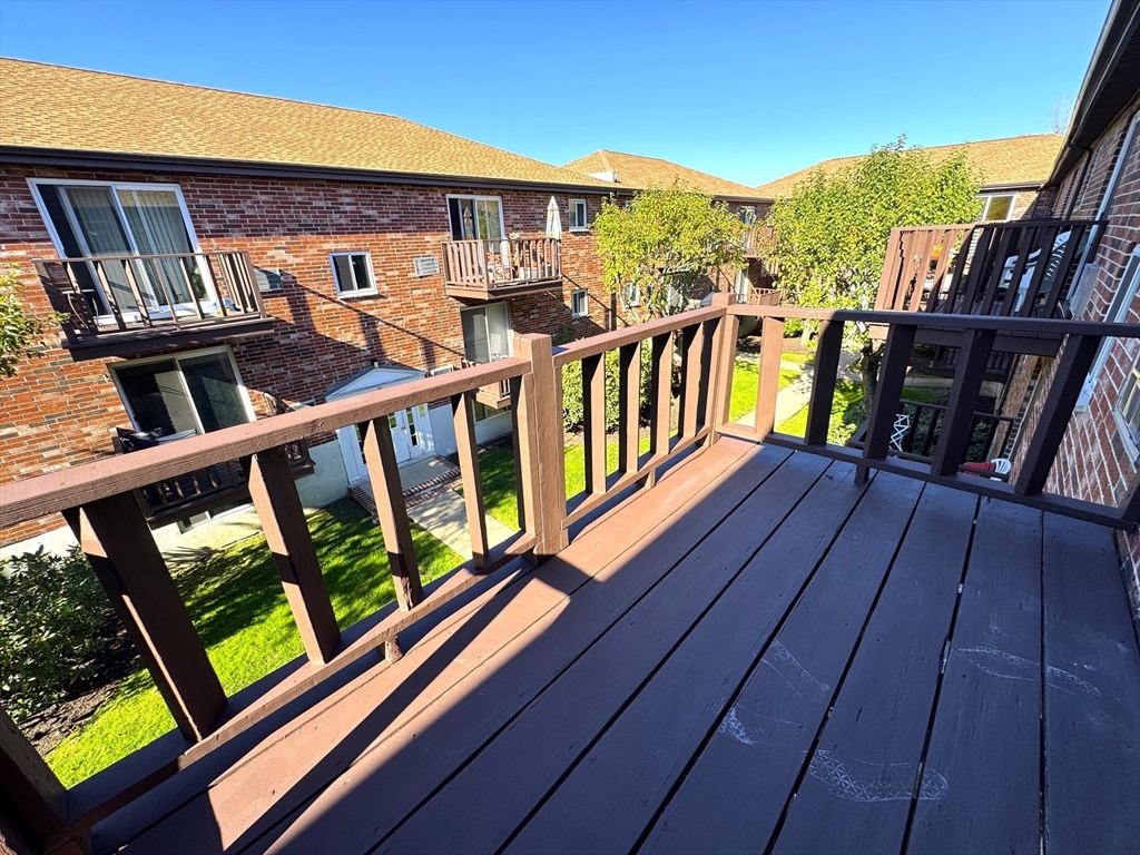 44 Westgate Road, Unit 5 Boston, MA 02467 - Photo 14 of 15 a view of a balcony with wooden floor and city view
