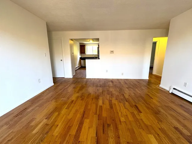 a view of a room with wooden floor