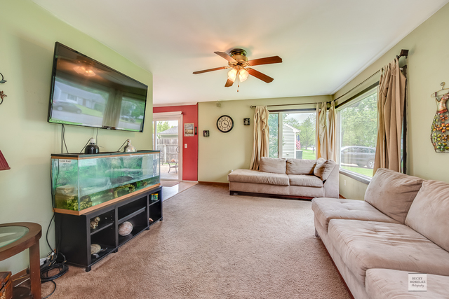 76 Fernwood Road Montgomery, IL 60538 - Photo 2 of 13 a living room with furniture and a flat screen tv