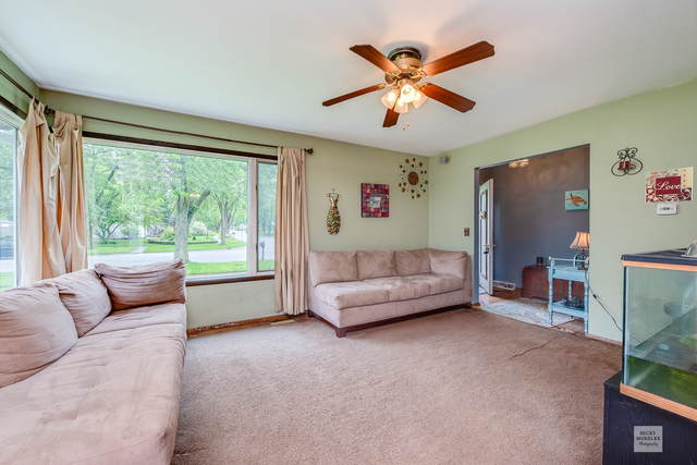 76 Fernwood Road Montgomery, IL 60538 - Photo 3 of 13 a living room with furniture and a large window