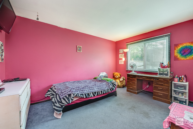 76 Fernwood Road Montgomery, IL 60538 - Photo 7 of 13 a bedroom with a bed and a dresser