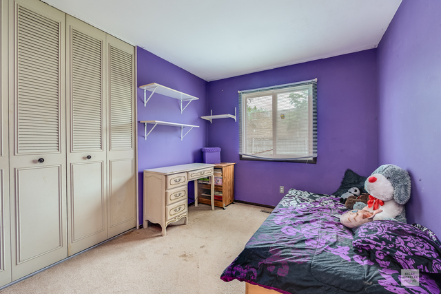 76 Fernwood Road Montgomery, IL 60538 - Photo 8 of 13 a bedroom with a bed and a window
