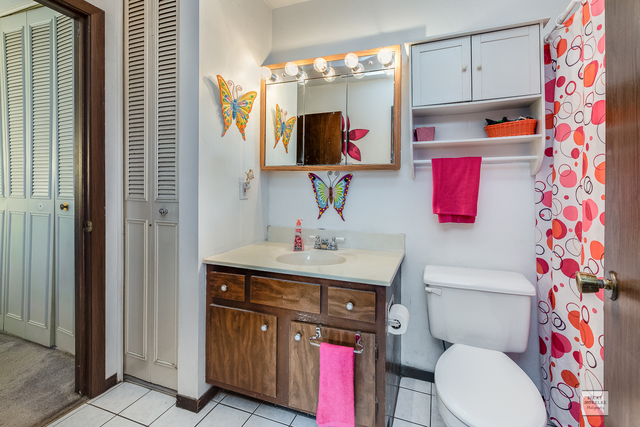 76 Fernwood Road Montgomery, IL 60538 - Photo 9 of 13 a bathroom with a toilet sink and mirror