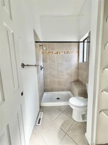 a bathroom with a toilet and a shower