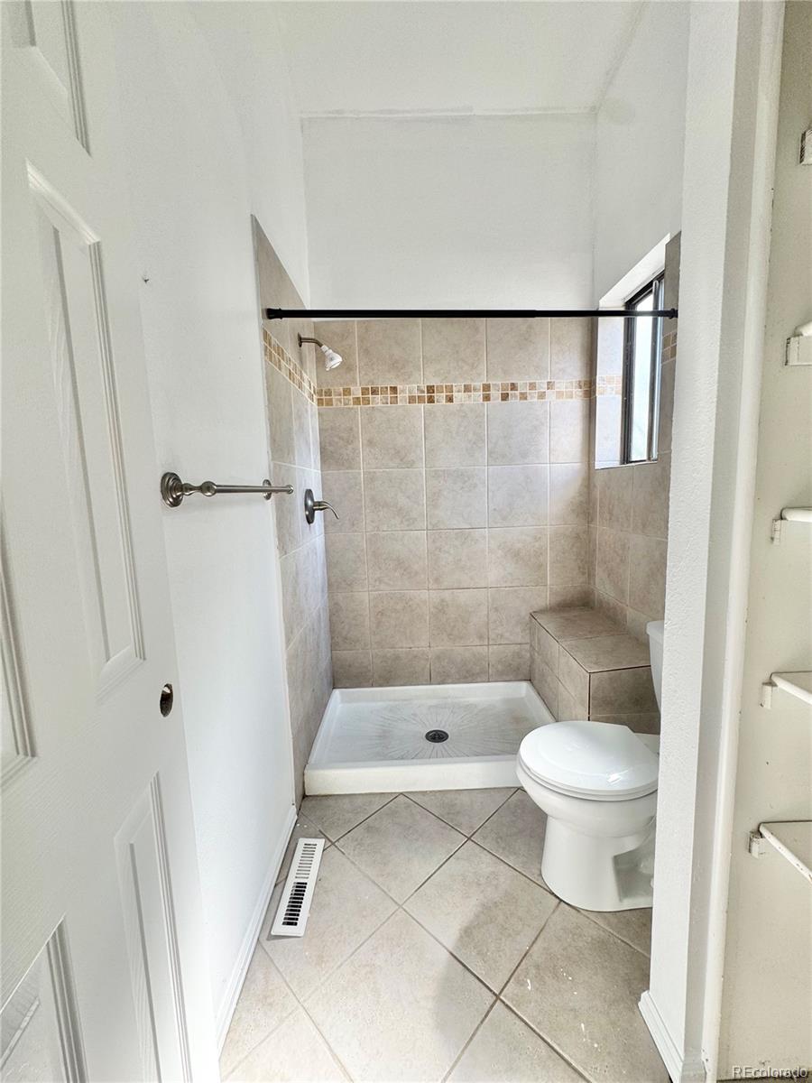 17938 East Amherst Avenue Aurora, CO 80013 - Photo 11 of 16 a bathroom with a toilet and a shower