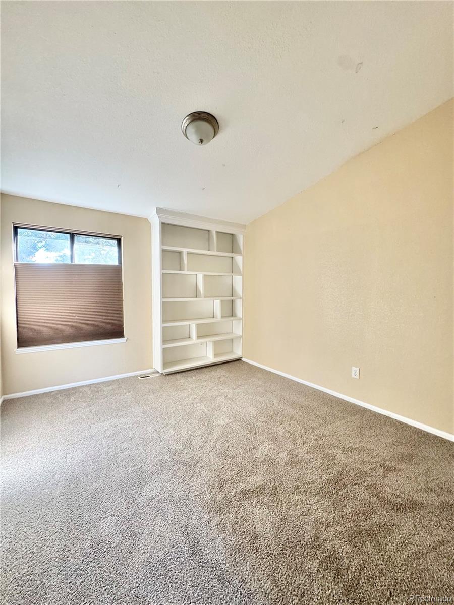 17938 East Amherst Avenue Aurora, CO 80013 - Photo 12 of 16 an empty room with fire place and windows