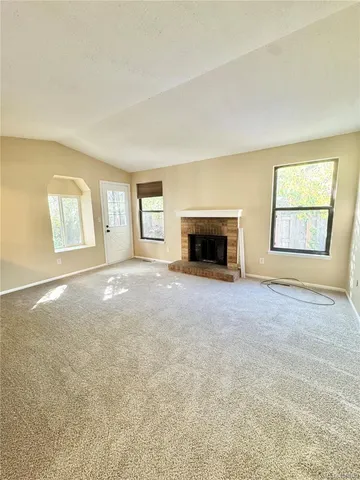 a view of empty room with a fireplace