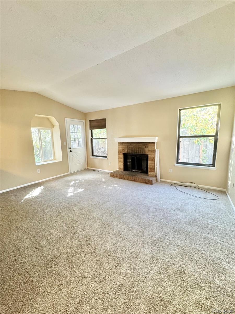 17938 East Amherst Avenue Aurora, CO 80013 - Photo 5 of 16 a view of empty room with a fireplace