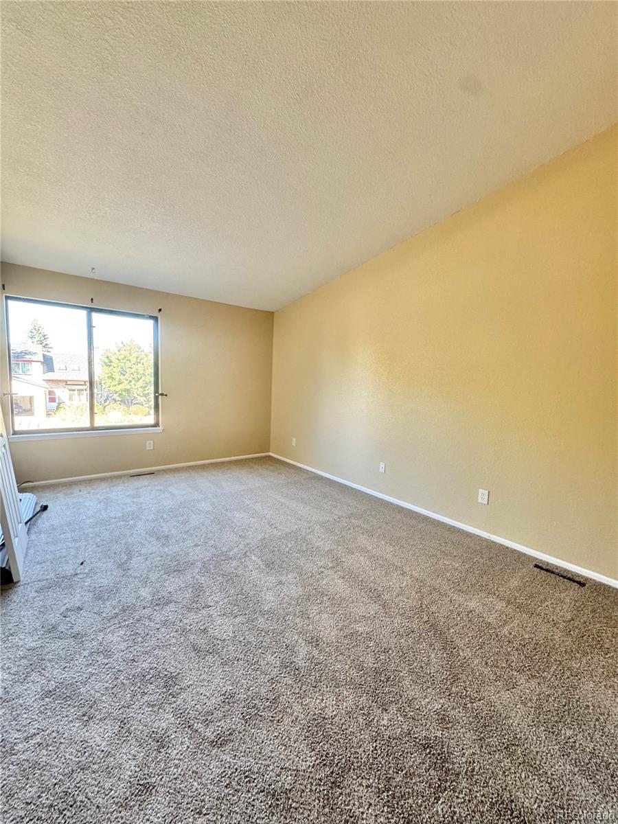 17938 East Amherst Avenue Aurora, CO 80013 - Photo 9 of 16 an empty room with a empty space and a window
