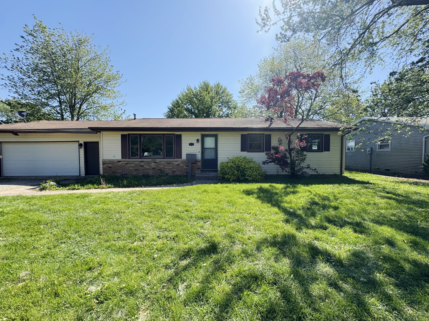 310 North 3rd Avenue Chenoa, IL 61726 - Photo 1 of 23 a front view of a house with a garden and plants