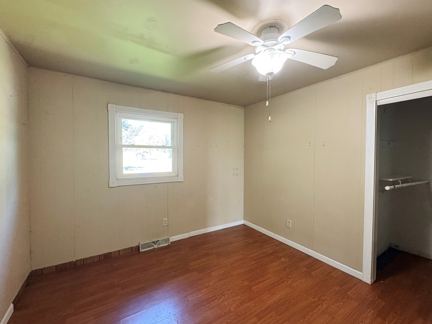 310 North 3rd Avenue Chenoa, IL 61726 - Photo 16 of 23 an empty room with wooden floor and windows