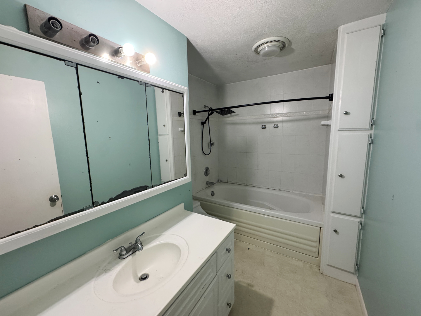 310 North 3rd Avenue Chenoa, IL 61726 - Photo 17 of 23 a bathroom with a sink a mirror and shower