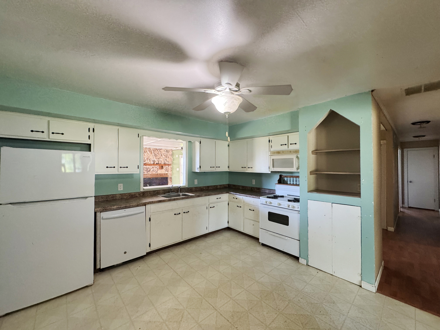 310 North 3rd Avenue Chenoa, IL 61726 - Photo 8 of 23 a kitchen with granite countertop white cabinets and white appliances