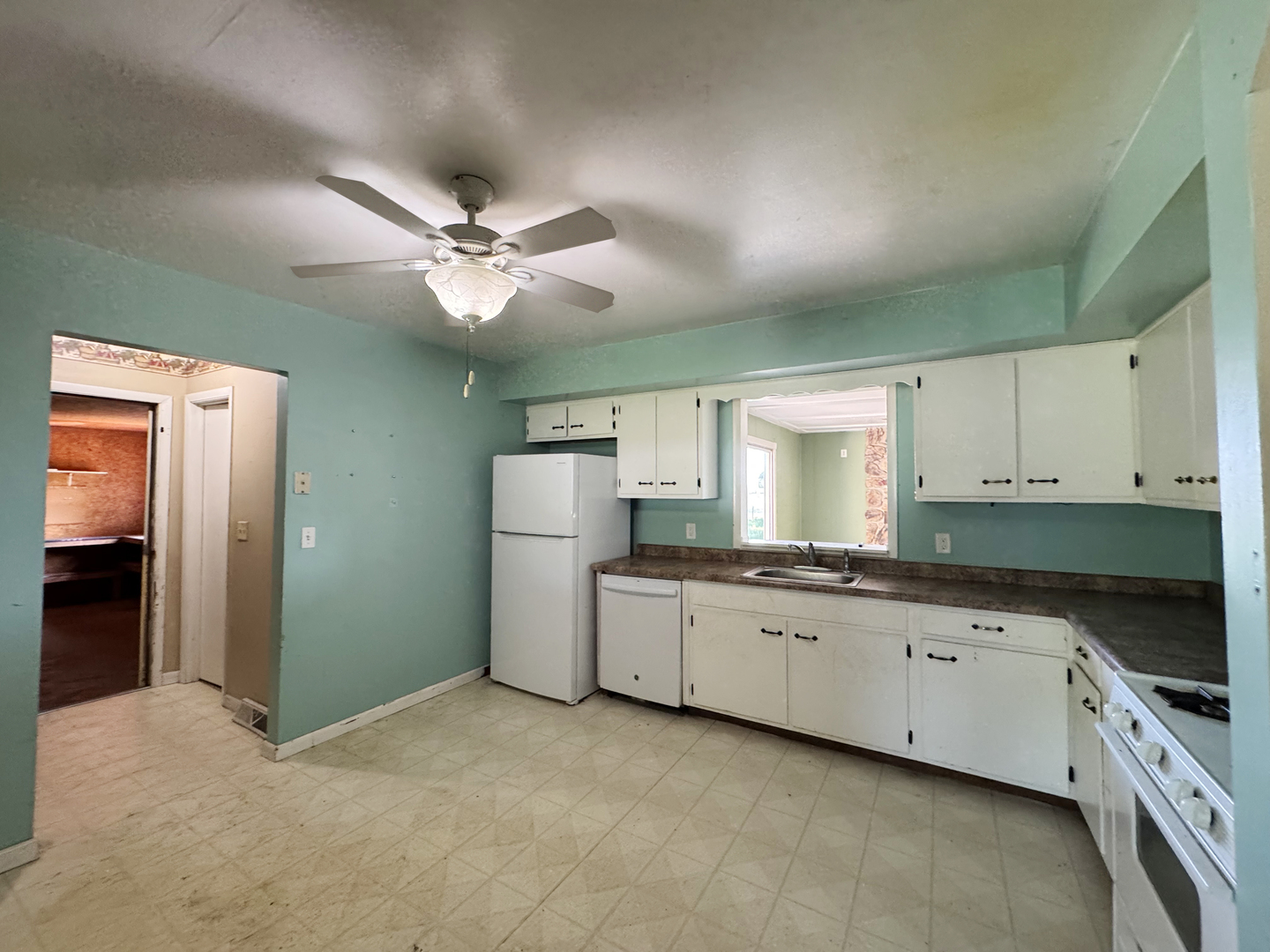 310 North 3rd Avenue Chenoa, IL 61726 - Photo 9 of 23 a kitchen with granite countertop a white stove top oven and sink