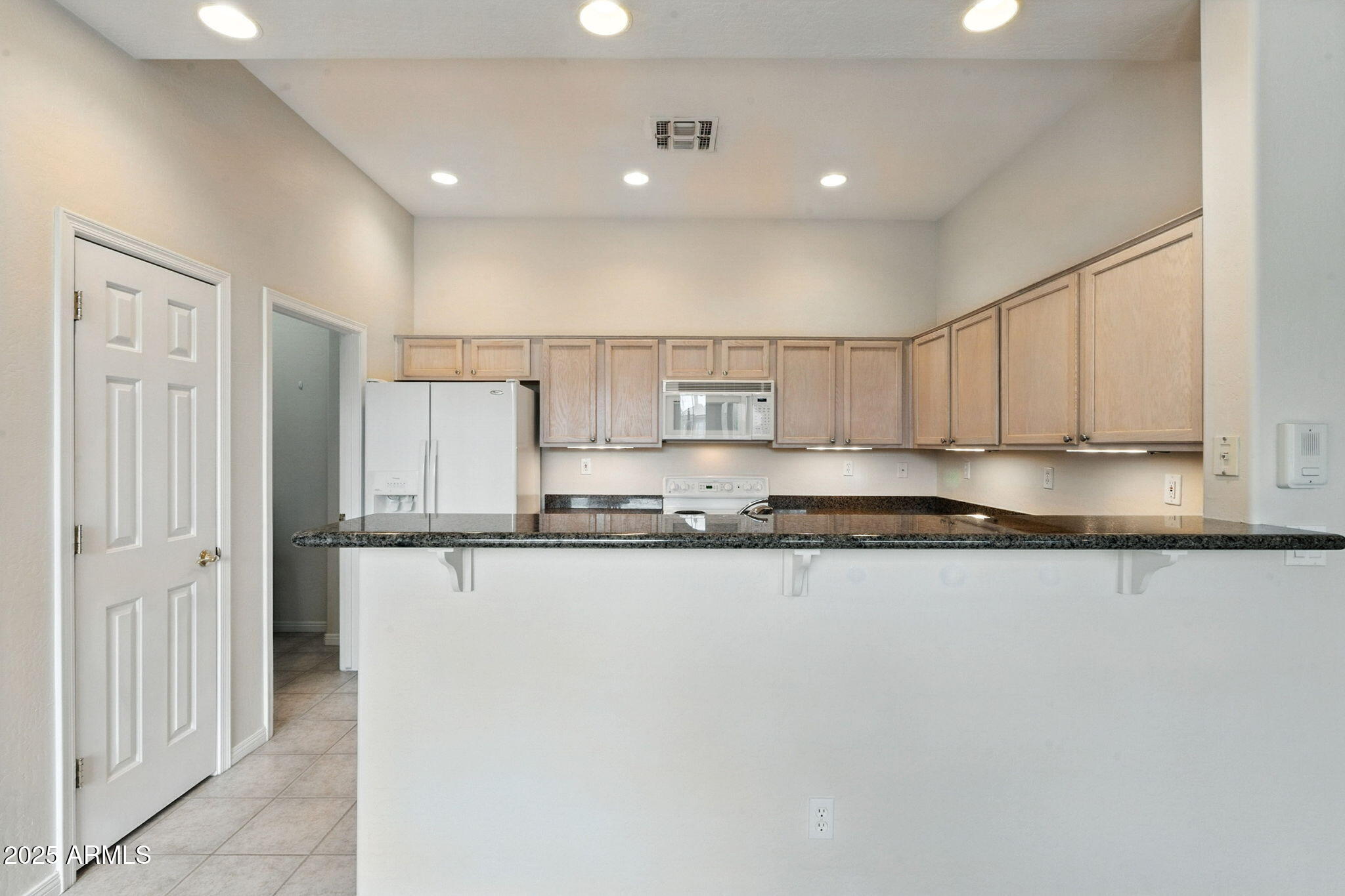 16420 North Thompson Peak Parkway, Unit 2031 Scottsdale, AZ 85260 - Photo 12 of 30 a large white kitchen with stainless steel appliances granite countertop a sink and cabinets