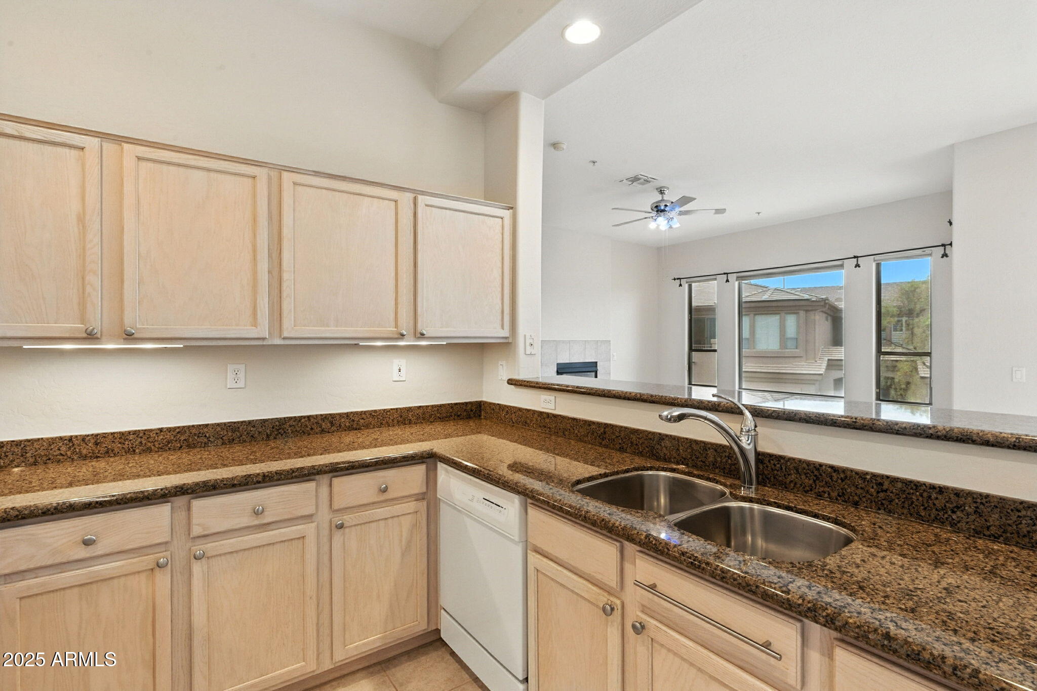 16420 North Thompson Peak Parkway, Unit 2031 Scottsdale, AZ 85260 - Photo 13 of 30 a kitchen with granite countertop a sink and white cabinets