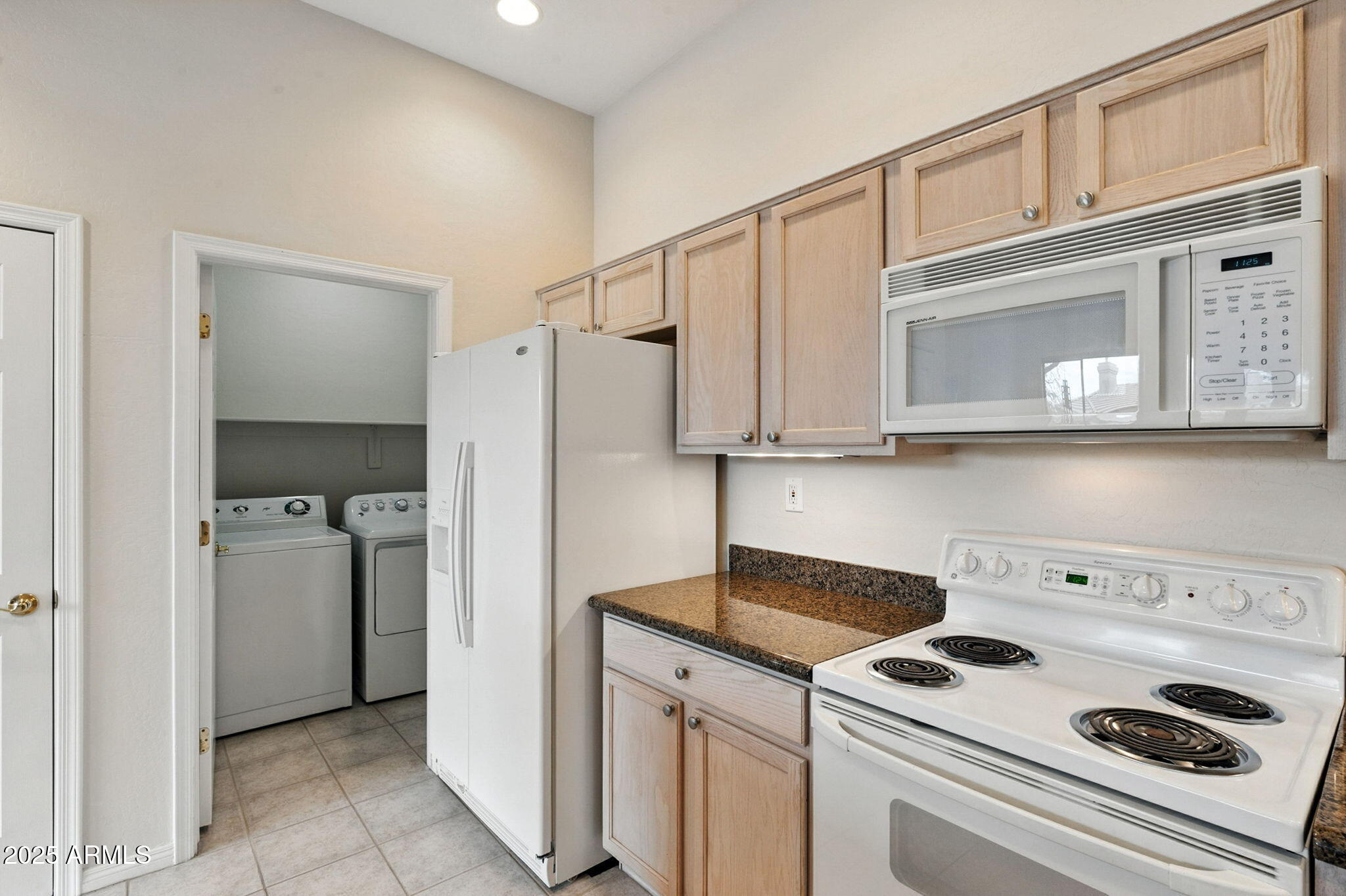 16420 North Thompson Peak Parkway, Unit 2031 Scottsdale, AZ 85260 - Photo 14 of 30 a kitchen with a refrigerator and white cabinets