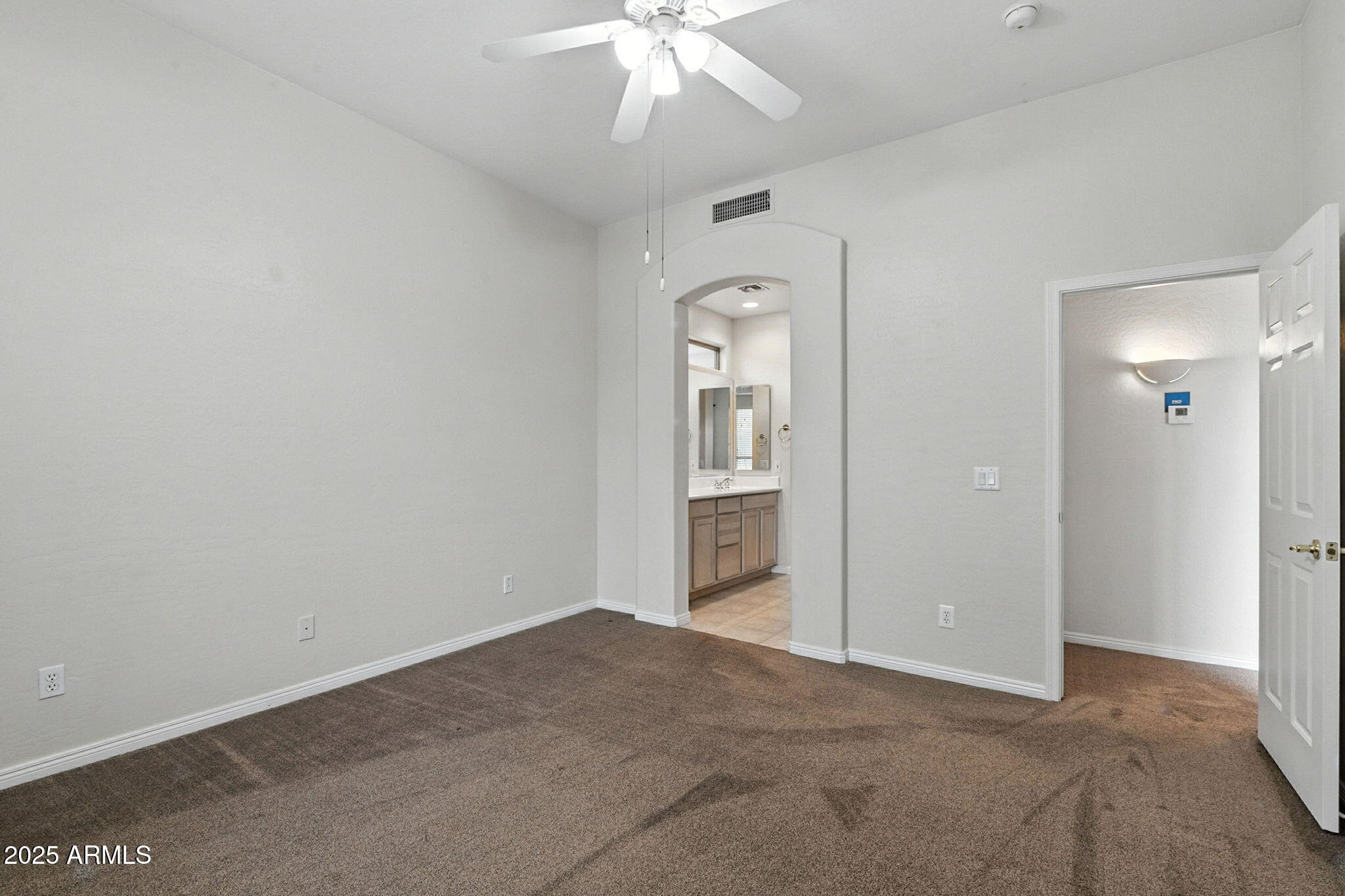 16420 North Thompson Peak Parkway, Unit 2031 Scottsdale, AZ 85260 - Photo 24 of 30 an empty room with fan and entrance